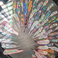 Some of the feathers coloured by students to create our collective mural